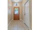 Inviting tiled entryway with decorative glass front door and white trim at 1171 Dartford Dr, Tarpon Springs, FL 34688