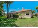 Charming single-Gathering home features a private screened lanai, complemented by mature landscaping and a well-maintained lawn at 1171 Dartford Dr, Tarpon Springs, FL 34688
