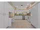 Bright kitchen features granite countertops, stainless steel appliances, and white cabinetry at 1171 Dartford Dr, Tarpon Springs, FL 34688