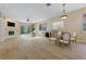 Bright living room with wood floors, fireplace, and sliding glass doors to the outdoor area at 1171 Dartford Dr, Tarpon Springs, FL 34688