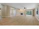 Open floor plan living room boasts modern floors, fireplace, and access to outdoor living at 1171 Dartford Dr, Tarpon Springs, FL 34688