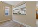 Cozy living room shows window looking into kitchen and front door access at 1171 Dartford Dr, Tarpon Springs, FL 34688
