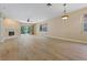 Bright living room features a fireplace, ceiling fan, and sliding glass doors to the outside at 1171 Dartford Dr, Tarpon Springs, FL 34688