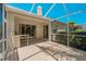 Screened lanai featuring an outdoor kitchen, plenty of shade, and dual sliding glass doors for easy indoor/outdoor living at 1171 Dartford Dr, Tarpon Springs, FL 34688