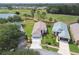 Aerial view of community featuring homes, manicured lawns, and a pond and golf course at 11732 Wheatfield Loop, Hudson, FL 34667
