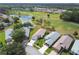Aerial view of homes overlooking lush golf course, pond and mature trees at 11732 Wheatfield Loop, Hudson, FL 34667
