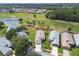 Aerial view of homes on a golf course community with water and tree views at 11732 Wheatfield Loop, Hudson, FL 34667