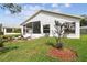 Back of house with enclosed patio and landscaped yard at 11732 Wheatfield Loop, Hudson, FL 34667