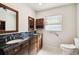 Bathroom with double sinks, framed mirrors, and granite counters at 11732 Wheatfield Loop, Hudson, FL 34667