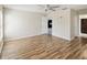 Bright bedroom features ceiling fan, neutral walls, and wood-look flooring at 11732 Wheatfield Loop, Hudson, FL 34667
