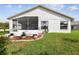 Back of house with patio and landscaped backyard at 11732 Wheatfield Loop, Hudson, FL 34667