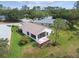 An exterior shot showcasing the back of a home with a screened-in lanai and well-kept lawn at 11732 Wheatfield Loop, Hudson, FL 34667