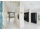 Bright, open foyer with neutral tile flooring, high ceilings, and views into the kitchen and living area at 11732 Wheatfield Loop, Hudson, FL 34667