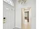 Entryway with tile flooring leading to bedroom, showcasing white walls and a bright, welcoming atmosphere at 11732 Wheatfield Loop, Hudson, FL 34667