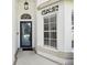 This front entrance showcases a glass-paneled door, decorative wall art, and classic design elements at 11732 Wheatfield Loop, Hudson, FL 34667