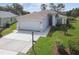 Charming single-story home featuring well-manicured lawn, two-car garage, and a welcoming front entrance at 11732 Wheatfield Loop, Hudson, FL 34667