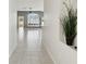 Hallway with tiled floors and views to living spaces at 11732 Wheatfield Loop, Hudson, FL 34667