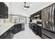 Updated kitchen featuring black cabinets, granite countertops, and stainless steel appliances at 11732 Wheatfield Loop, Hudson, FL 34667