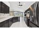 Spacious kitchen with black cabinets, granite countertops, and stainless steel appliances at 11732 Wheatfield Loop, Hudson, FL 34667