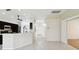Bright open concept kitchen and living area with black appliances, tile flooring, and lots of natural light at 11732 Wheatfield Loop, Hudson, FL 34667