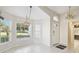 Light-filled dining area with tile flooring and decorative lighting, offering open flow throughout home at 11732 Wheatfield Loop, Hudson, FL 34667