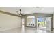 Sunlit living room featuring large windows and neutral tones at 11732 Wheatfield Loop, Hudson, FL 34667
