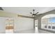 Open living room with tile floors, ceiling fan and multiple windows providing natural light at 11732 Wheatfield Loop, Hudson, FL 34667
