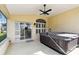 Screened in patio featuring spa and view of the backyard and golf course at 11732 Wheatfield Loop, Hudson, FL 34667