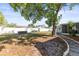 Expansive backyard with mature trees, a privacy fence, and stone walkway to the screened in porch at 12065 Shadow Ridge Blvd, Hudson, FL 34669