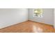 Bright bedroom featuring hardwood floors, a window, and white walls at 12065 Shadow Ridge Blvd, Hudson, FL 34669