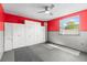 Finished bonus room provides extra storage with built-in cabinets, large window, and ceiling fan at 12065 Shadow Ridge Blvd, Hudson, FL 34669