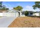 Charming single-story home featuring an attached garage and well-maintained front yard at 12065 Shadow Ridge Blvd, Hudson, FL 34669