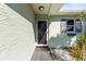 Inviting front entrance with storm door, shuttered window and greenery at 12065 Shadow Ridge Blvd, Hudson, FL 34669