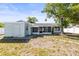 Charming single-story home featuring a screened porch and mature tree in a tranquil setting at 12065 Shadow Ridge Blvd, Hudson, FL 34669