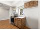 Kitchen featuring white walls, wood flooring and cabinetry and modern appliances at 12065 Shadow Ridge Blvd, Hudson, FL 34669