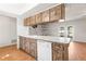 Kitchen featuring wood cabinets, white appliances, and wood flooring at 12065 Shadow Ridge Blvd, Hudson, FL 34669