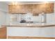 Bright kitchen featuring a white countertop, wood cabinets, and modern appliances at 12065 Shadow Ridge Blvd, Hudson, FL 34669