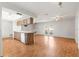Open-concept kitchen and living room with wood flooring and modern lighting at 12065 Shadow Ridge Blvd, Hudson, FL 34669
