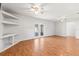 Spacious living room featuring wood floors and access to outdoor patio via glass doors at 12065 Shadow Ridge Blvd, Hudson, FL 34669