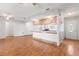 Open living space with wood floors flowing into the kitchen and dining areas at 12065 Shadow Ridge Blvd, Hudson, FL 34669