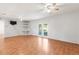 Bright and airy living room with access to the backyard through glass patio doors at 12065 Shadow Ridge Blvd, Hudson, FL 34669