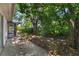 Backyard featuring a mature tree providing shade with the screened in porch at 12204 Pepper Mill Dr, Hudson, FL 34667