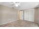 Neutral bedroom featuring carpeted floors, a ceiling fan, and closet with louvered doors at 12204 Pepper Mill Dr, Hudson, FL 34667