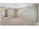 Bright, carpeted bedroom with a ceiling fan, closet access, and a large window at 12204 Pepper Mill Dr, Hudson, FL 34667