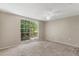 Neutral bedroom with carpet and large window at 12204 Pepper Mill Dr, Hudson, FL 34667