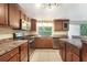 Well-lit kitchen features stainless appliances, ample counter space and custom cabinets at 12204 Pepper Mill Dr, Hudson, FL 34667