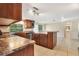 Open kitchen features granite countertops and a center island perfect for entertaining at 12204 Pepper Mill Dr, Hudson, FL 34667