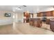 The kitchen and open living area features wood cabinets, stainless appliances and updated floors at 12204 Pepper Mill Dr, Hudson, FL 34667