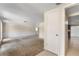 Spacious living room featuring neutral carpet, fresh paint, and an open layout at 12204 Pepper Mill Dr, Hudson, FL 34667
