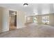 Open living room area with natural light, neutral tones, and tile flooring in the adjacent space at 12204 Pepper Mill Dr, Hudson, FL 34667
